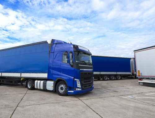 Truck vehicle with trailers in background.